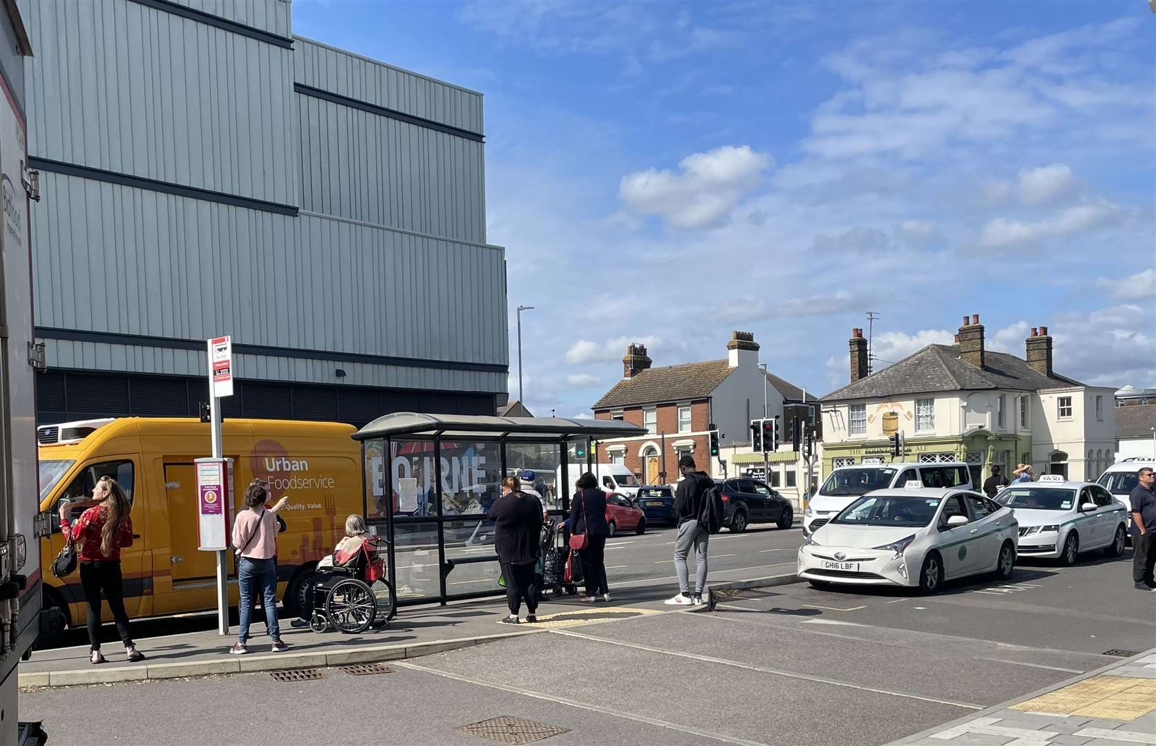 People waiting for a bus at the bus stop in in Sittingbourne