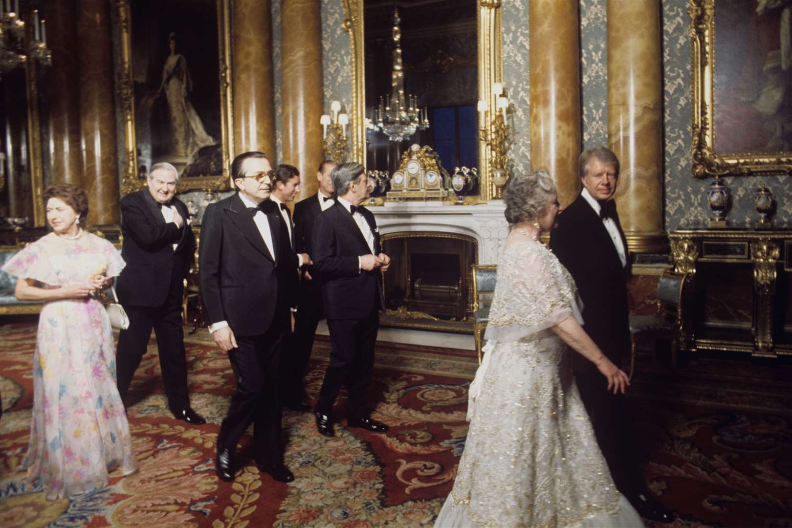 The Queen Mother walks with President Jimmy Carter in the Blue Drawing Room at Buckingham Palace (Archive/PA)