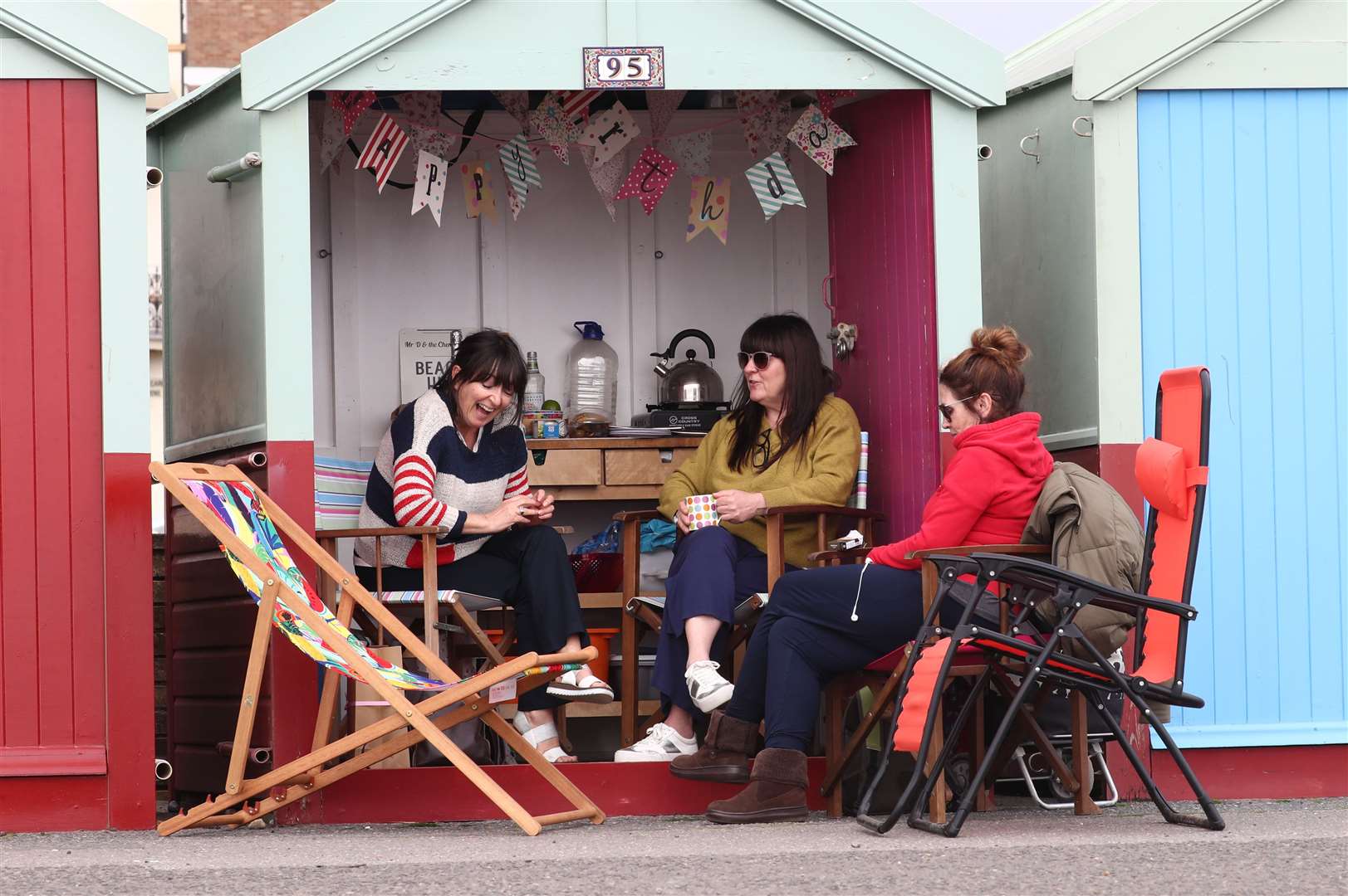 Women at a beach hut in Brighton (Gareth Fuller/PA)