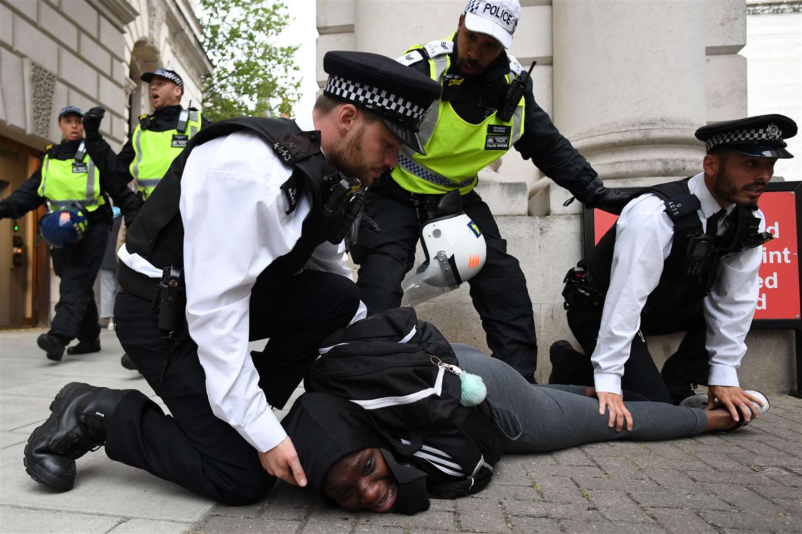 Police officers detain a protester on Whitehall (Stefan Rousseau/PA)