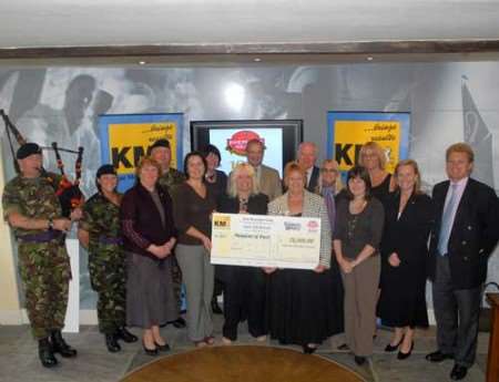 Shepherd Neame chief executive Jonathan Neame and Kent Messenger Group chairman Geraldine Allinson (right) with the recipients of the 10 cheques. Picture: BARRY DUFFIELD