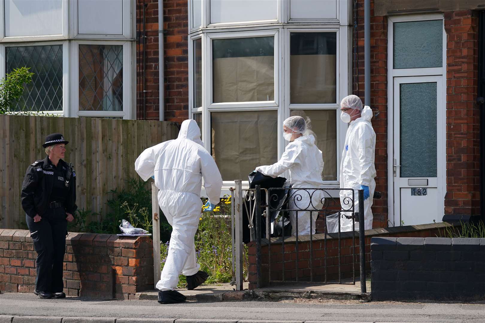 Police officers at the scene in High Holme Road, Louth (Joe Giddens/PA)