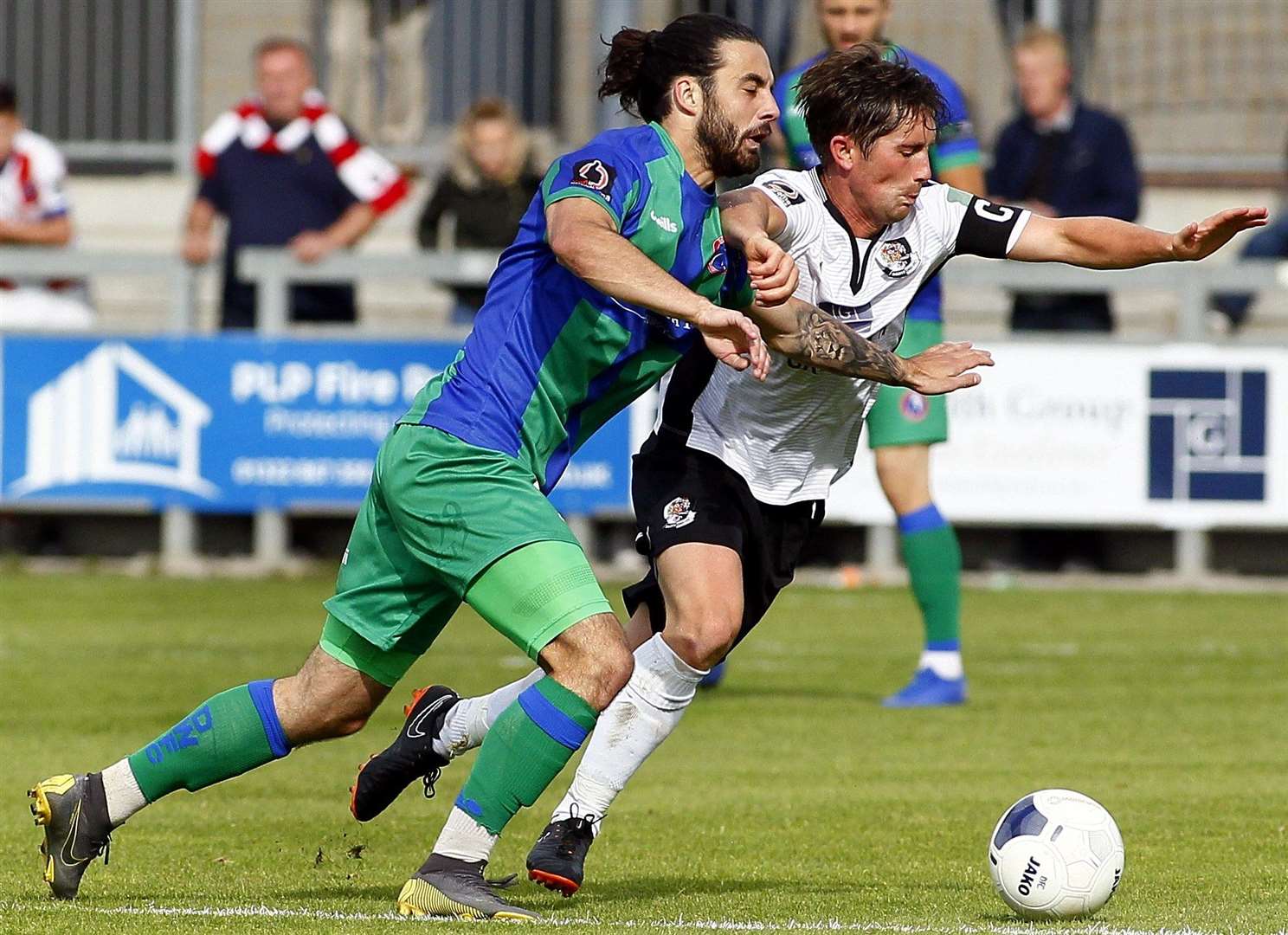 Dartford's Lee Noble holds off Dorking Wanderers' Daniel Gallagher. Picture: Sean Aidan