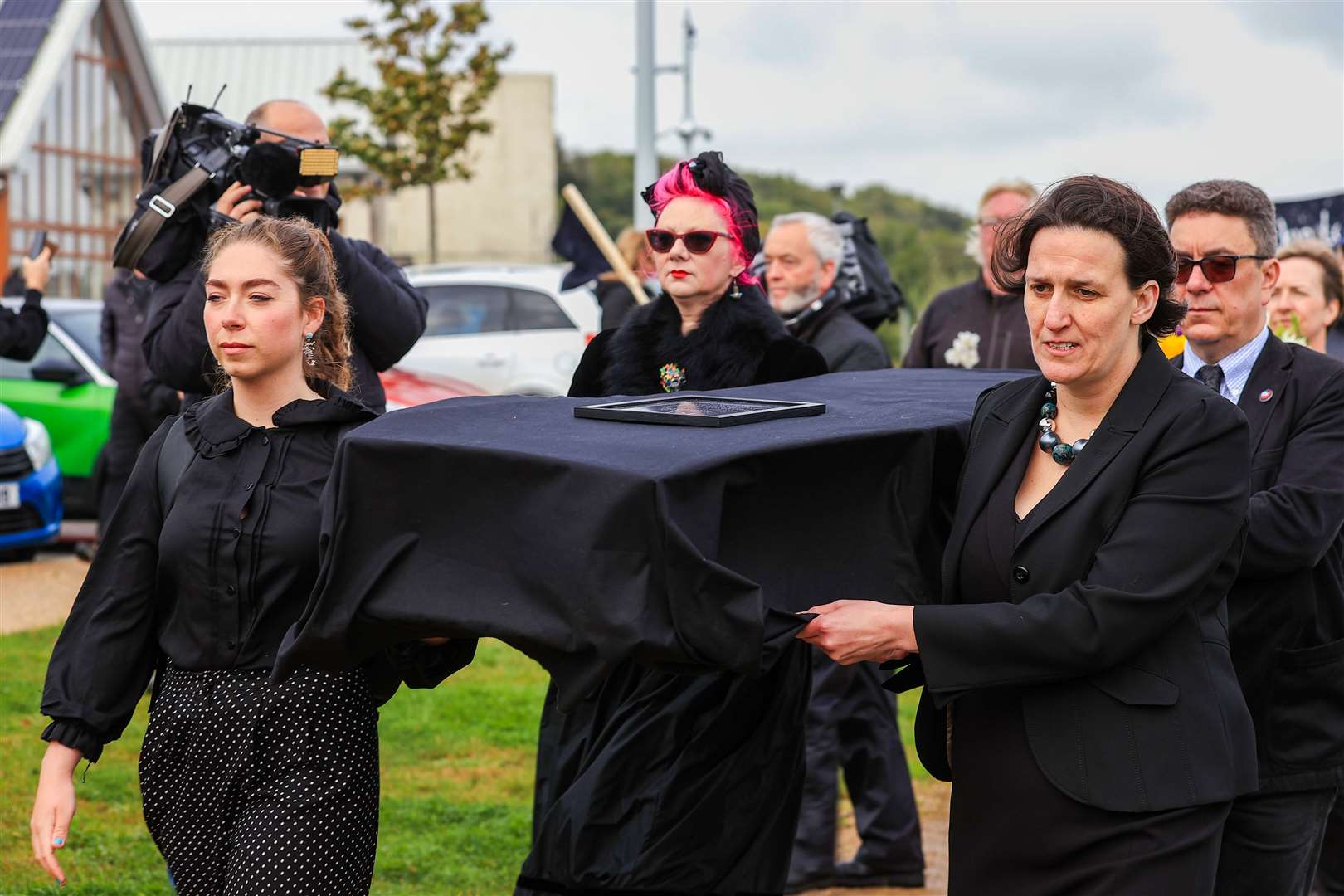 Dr Louise Taylor (front right) helps carry a box to symbolise a coffin (Liam McBurney/PA)