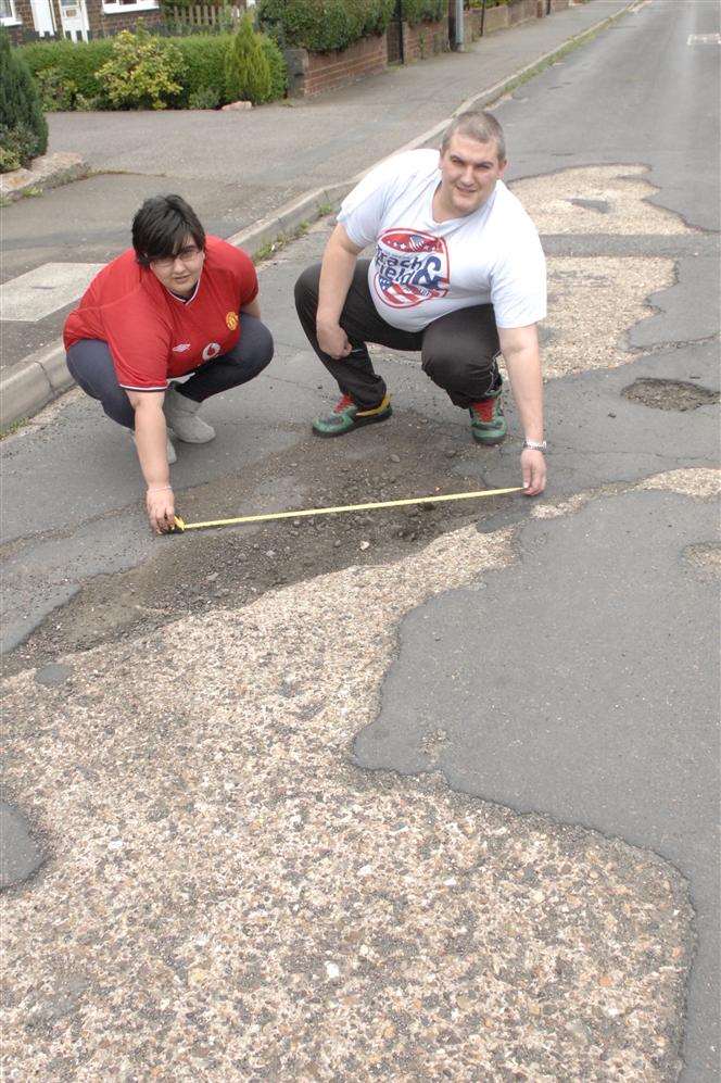 Lorna and Trevor Blackley with one of the potholes in Chalk Road, Queenborough