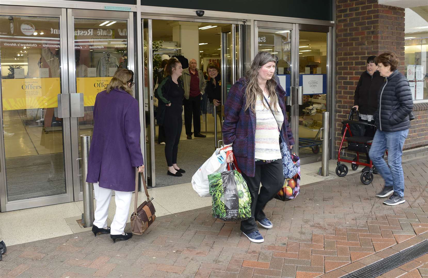 One of the last shoppers, Colette Post, leaves with full bags in 2019