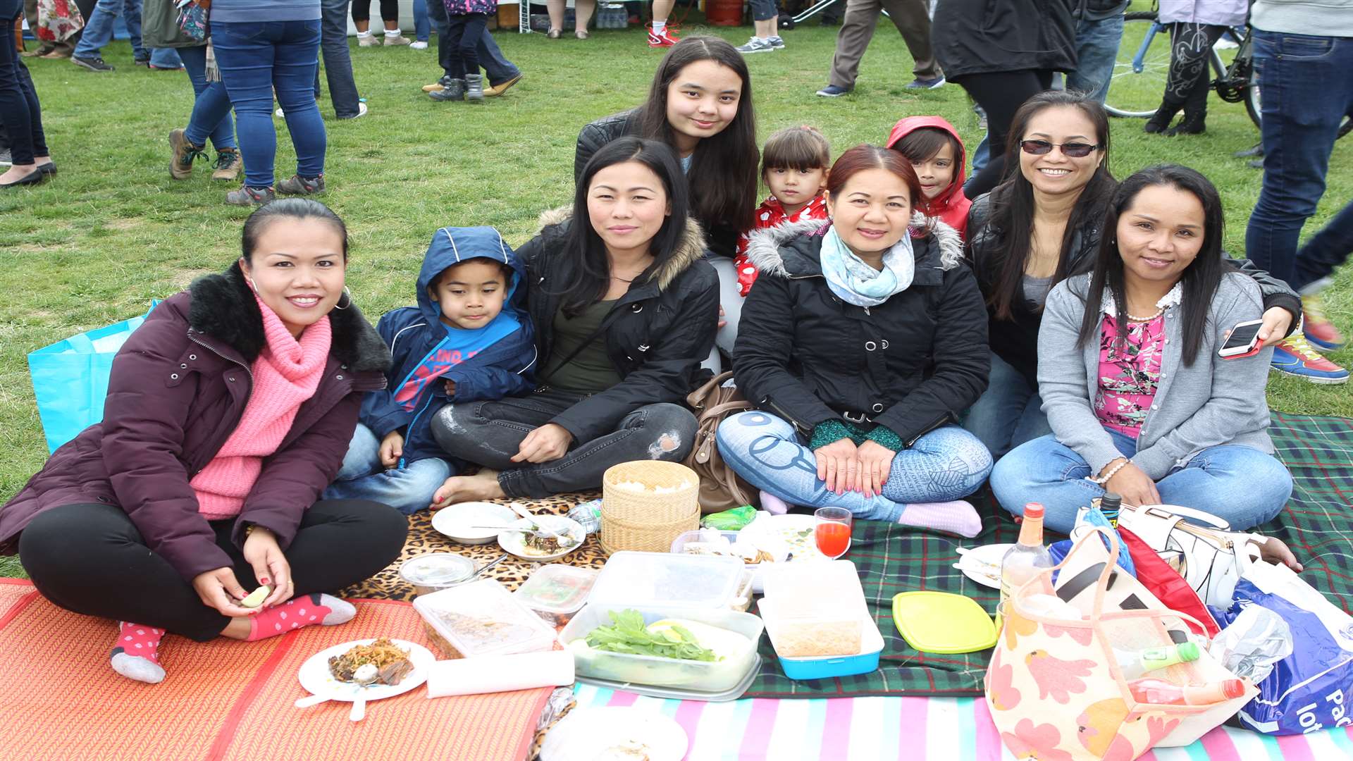 Friends at Maidstone Mela at Mote Park in Maidstone. Picture: John Westhrop.