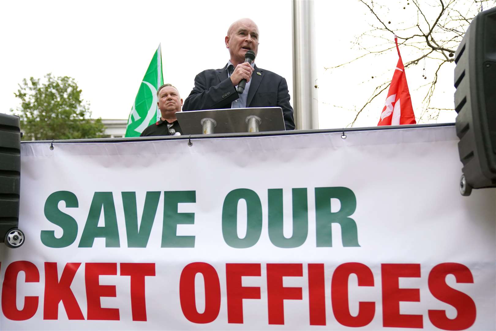 Rail, Maritime and Transport (RMT) union general secretary Mick Lynch speaking at a rally as Alex Gordon RMT president (left) listens outside King’s Cross station, in London (Jonathan Brady/PA)