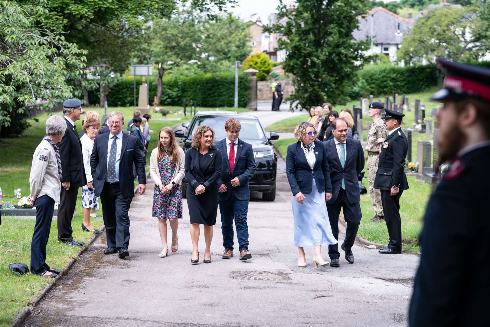 Relatives of Captain Sir Tom Moore (from left) Colin Ingram-Moore (son in law), Georgia Ingram-Moore (granddaughter), Hannah Ingram-Moore (daughter), Benjie Ingram-Moore (grandson), Lucy Teixeira (daughter) and Tom Teixeira (son in law), walk through a guard of honour ahead of burying Sir Tom’s ashes at his family’s grave in Morton Cemetery, Riddlesden (Danny Lawson/PA)