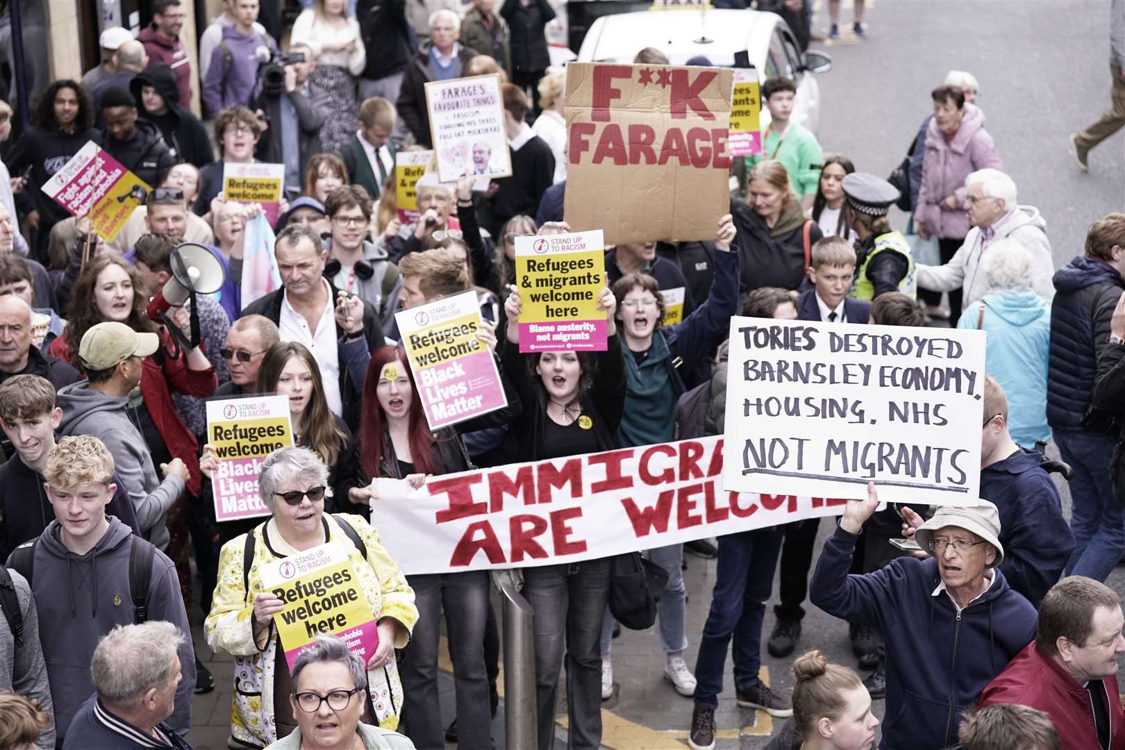 However, not everyone greeted the Reform UK leader warmly, with one speech from the top of his campaign bus in Yorkshire greeted by posters and placards saying immigrants were welcome (Danny Lawson/PA)