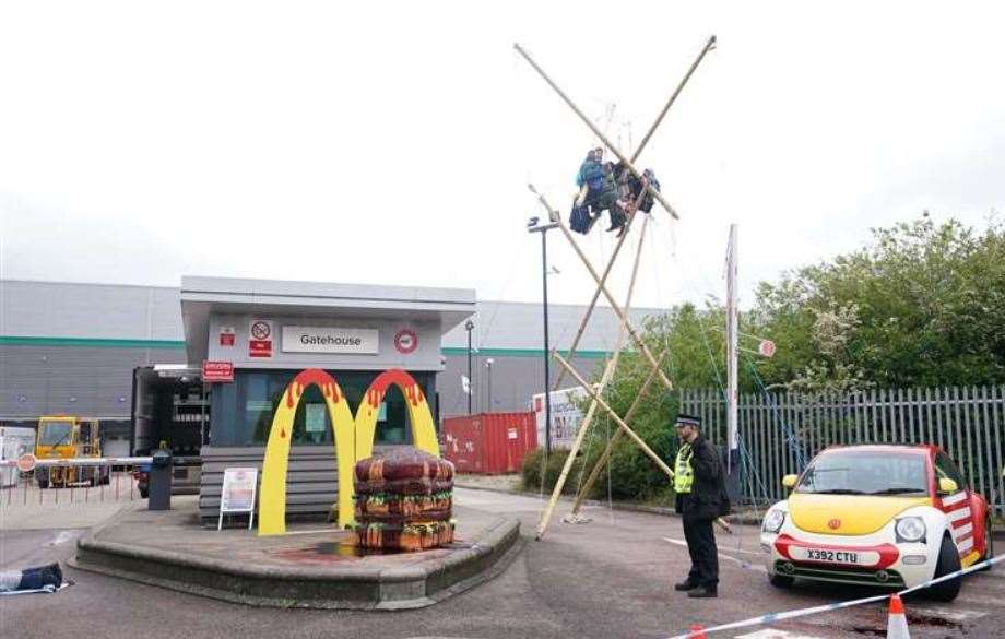 Animal Rebellion protesters suspended from a bamboo structure outside a McDonald’s distribution site in Hemel Hempstead. Picture Yui Mok/ PA