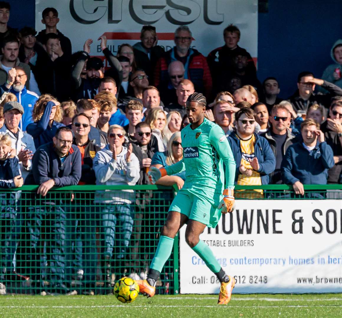 Maidstone goalkeeper Alexis Andre Jr passes forward with the crowd behind him. Picture: Helen Cooper