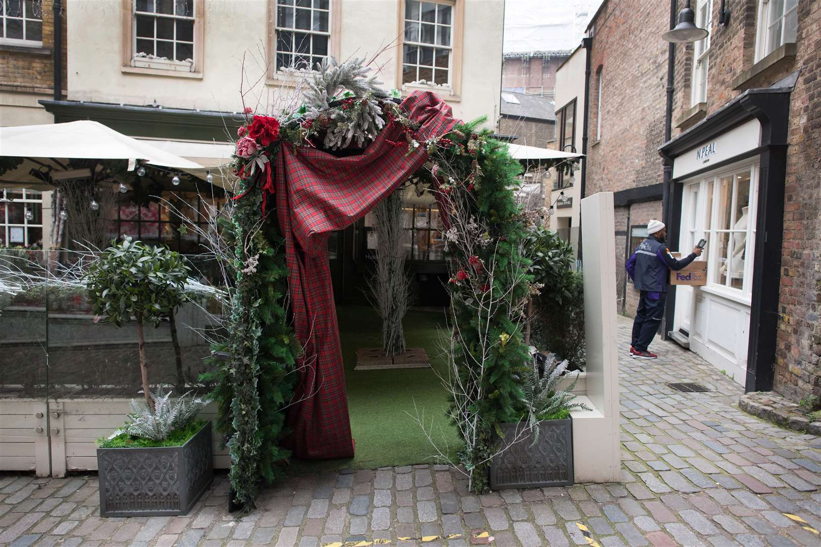 Christmas decorations still adorn a restaurant in Horseshoe Yard in London (Stefan Rousseau/PA)