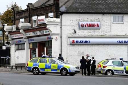 Police officers at the scene shortly after the raid