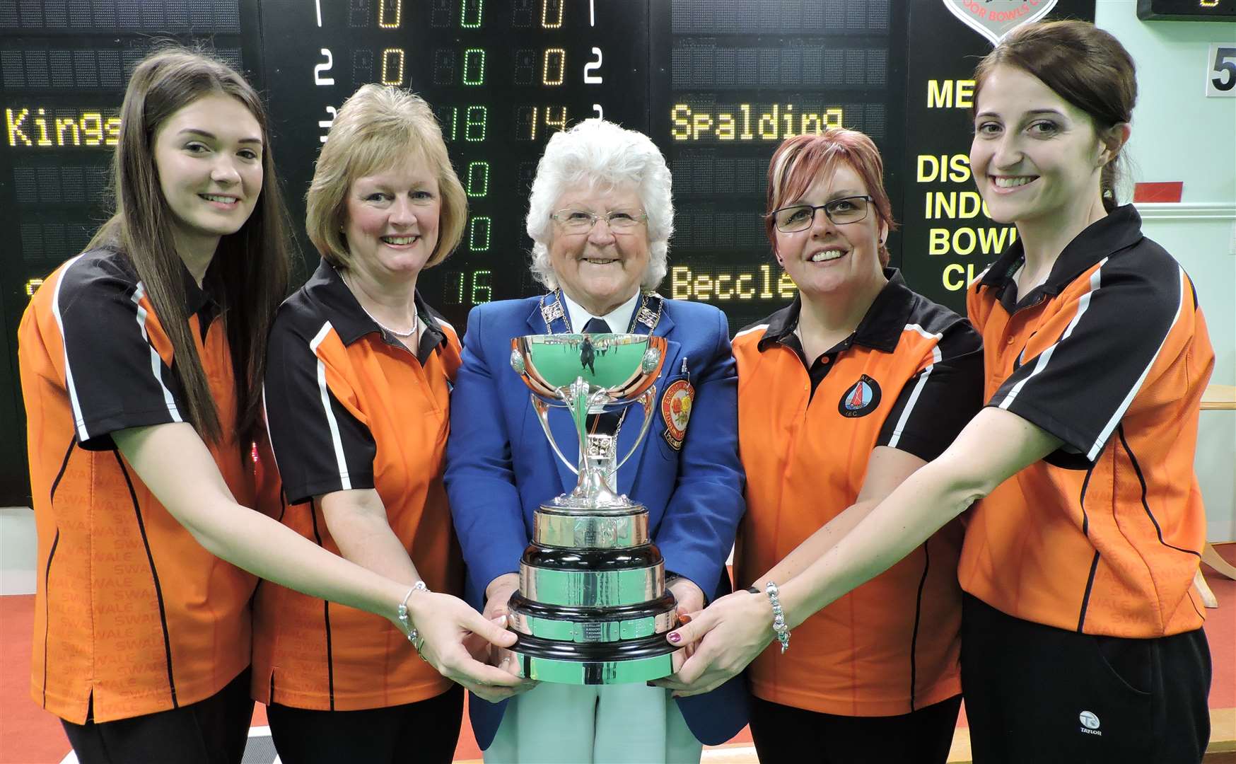 Swale Bowls Club's Imogen Jenner, Sandy Hazell, Wendy King and Paige Dennis celebrate their National Fours triumph with EIBA president Margaret Allen Picture: EIBA