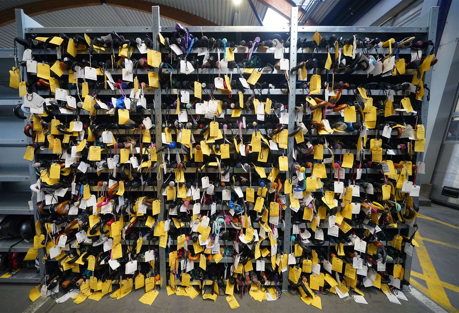 Shelves of umbrellas at TfL’s lost property office (Yui Mok/PA)