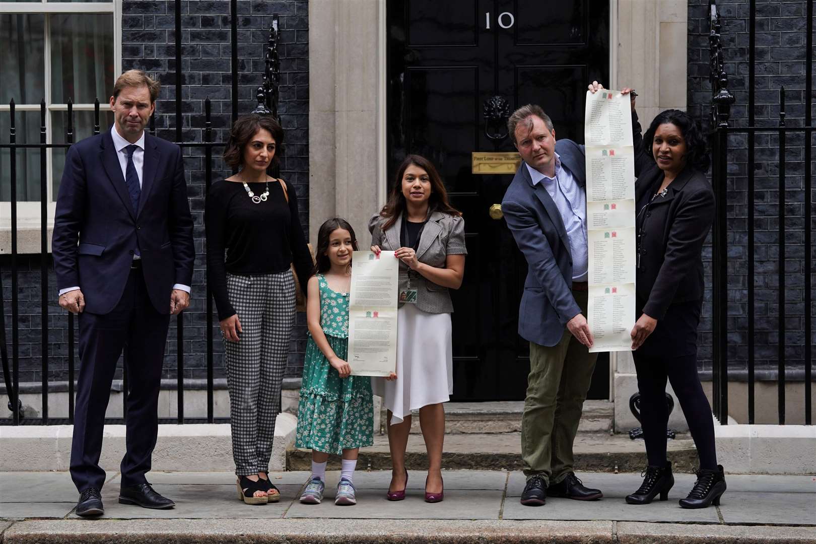 Richard Ratcliffe, second right, and his daughter Gabriella and supporters hand in a petition to 10 Downing Street to mark the 2,000th day of Ms Zaghari-Ratcliffe’s detention (Kirsty O’Connor/PA)