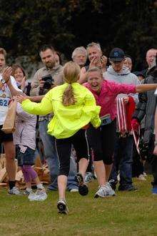 Melanie Carley congratulating her daughter Jessica Carley, 10, on her return in the Demelza run.