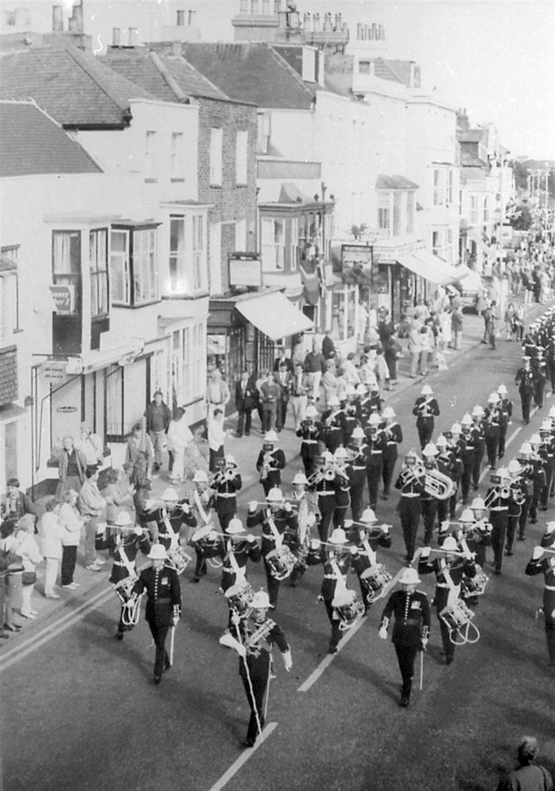 Townpeople watched as the band marched through the streets of Deal leaving empty spaces for those killed