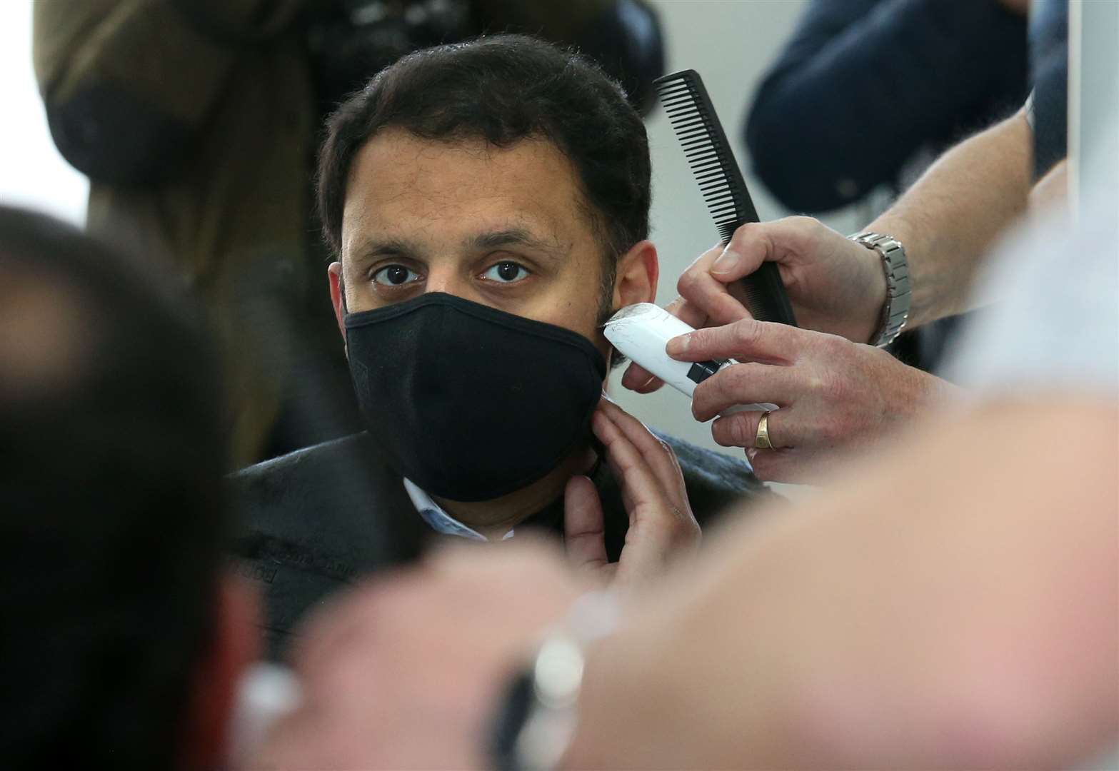 Scottish Labour leader Anas Sarwar has his hair cut by barber Mark Stephen at Oceanic Hair Salon in Glasgow (Andrew Milligan/PA)