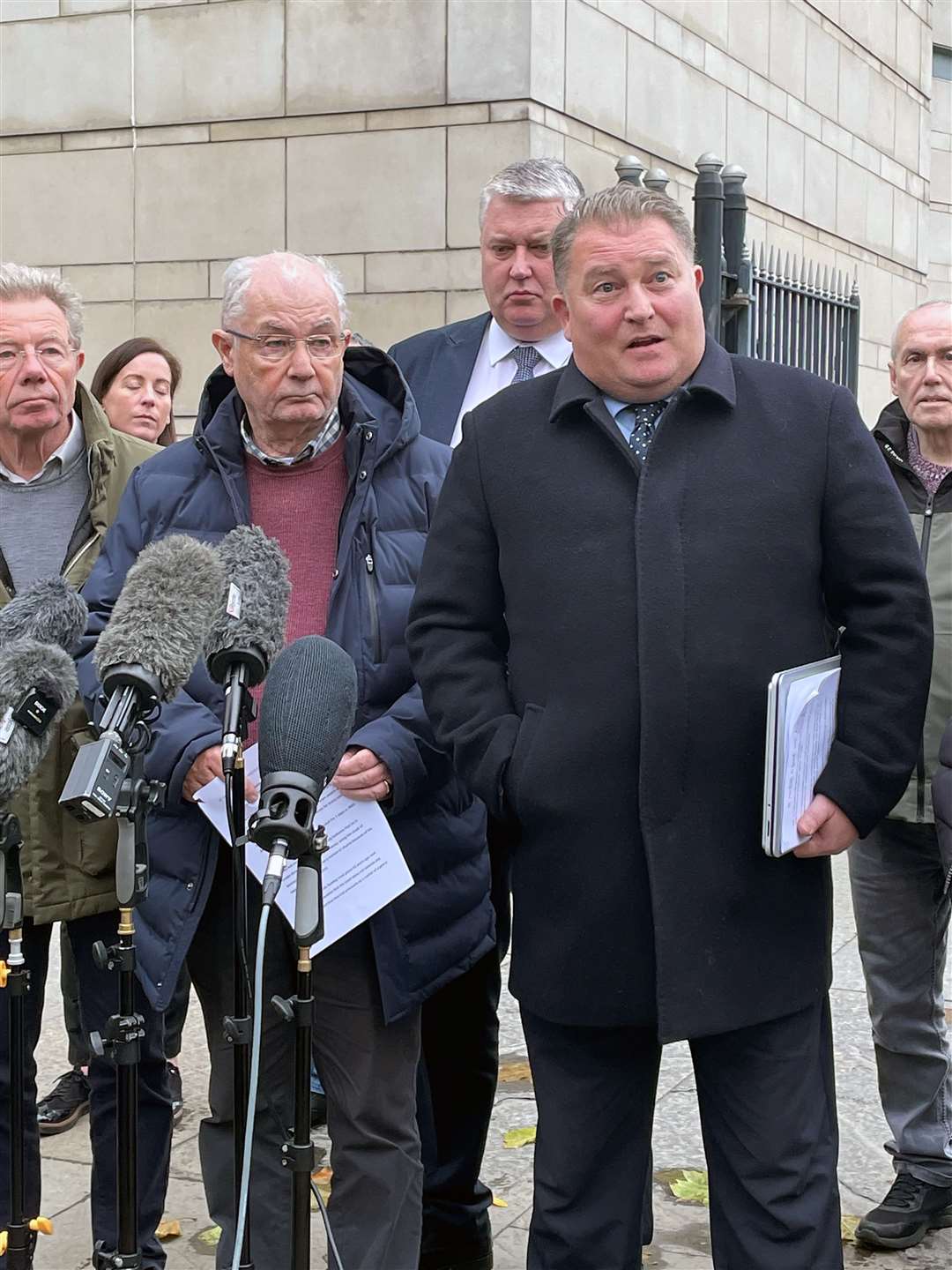 Ciaran Shiels, second from right, solicitor for the Bloody Sunday families spoke to the media outside Belfast Crown Court on Friday (David Young/PA)