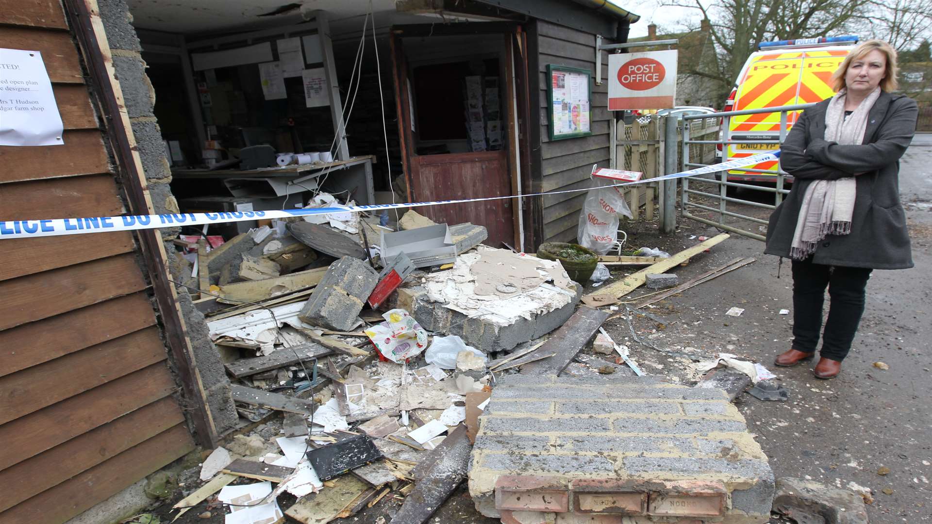 Sub-postmaster, Teresa Hudson looks at the damage