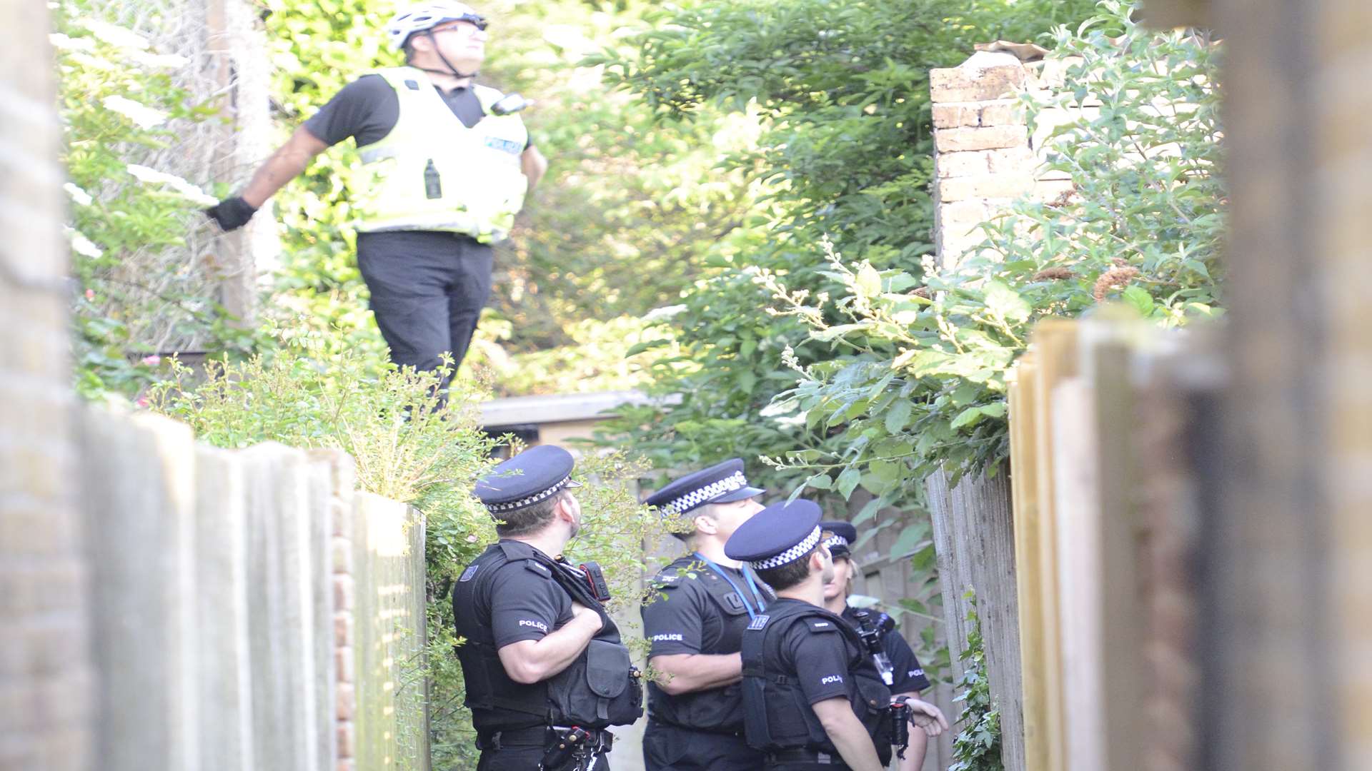 Police in an alleyway off the High Street. Picture: Chris Davey.