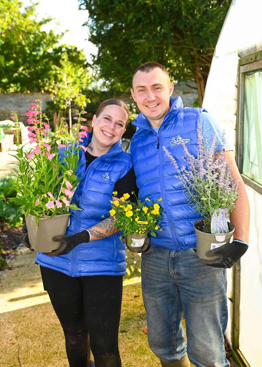 Lottery winners Katherine and Graeme White help spruce up a garden for toddlers at Sacrewell Farm in Peterborough (National Lottery/PA)