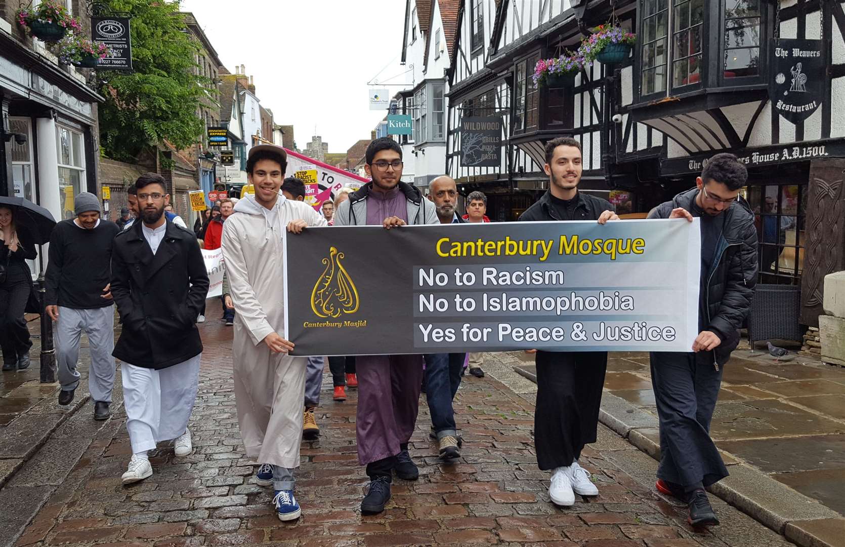 Representatives from Canterbury Mosque march along the high street