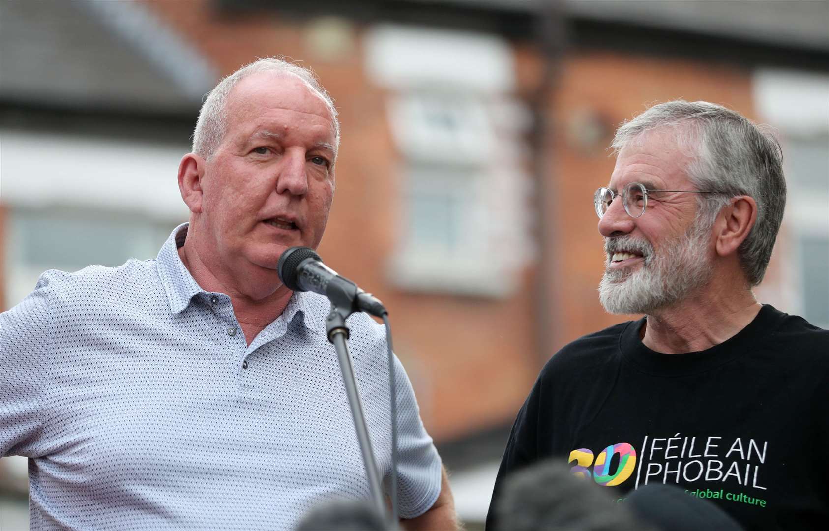 Bobby Storey, left, and Gerry Adams address a rally in west Belfast after their homes were attacked in 2018 (Niall Carson/PA)