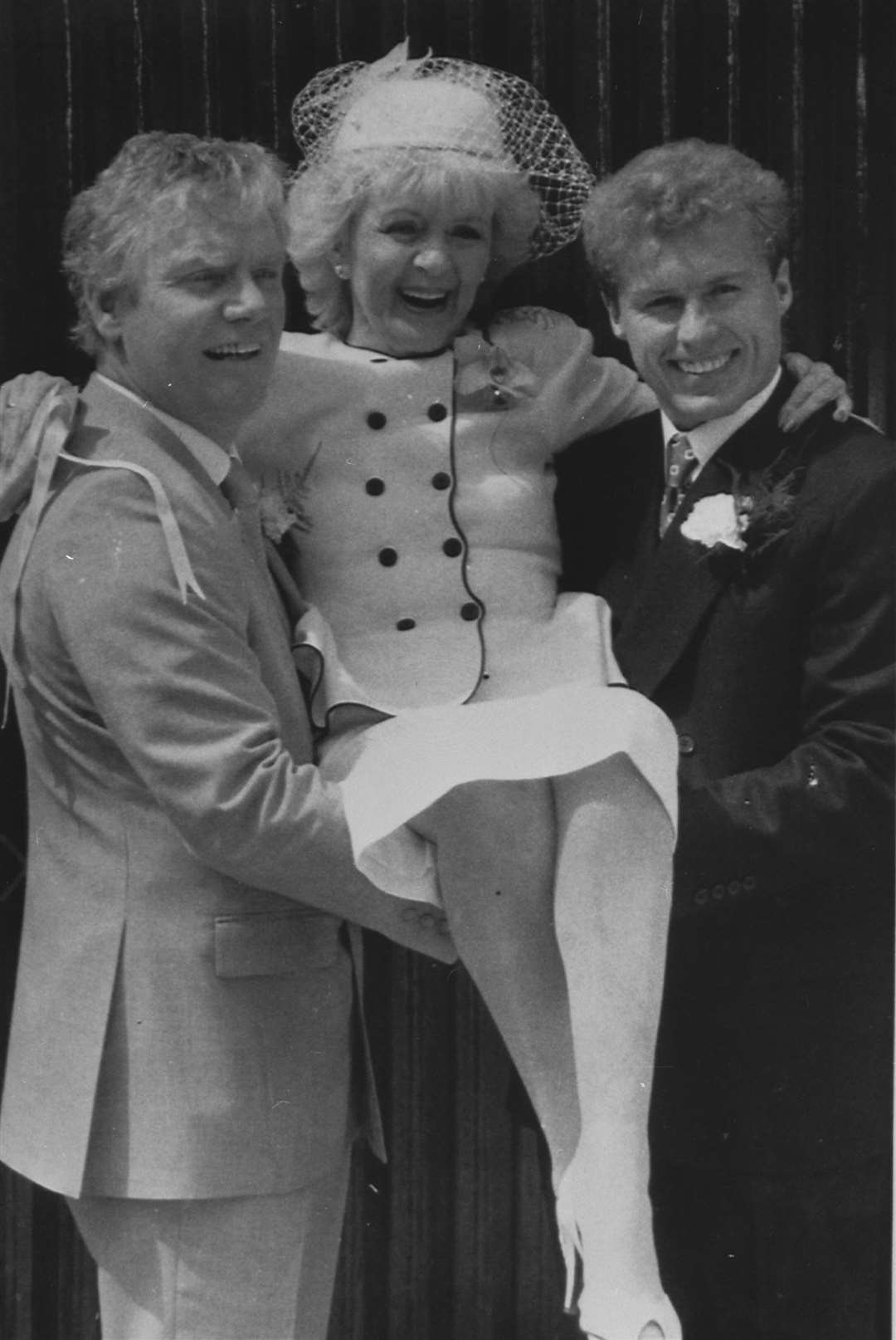 Coronation Street bride Ivy Tilsley is given a lift by her on-screen groom, Don Brennan, left, and on-screen son Brian (PA)