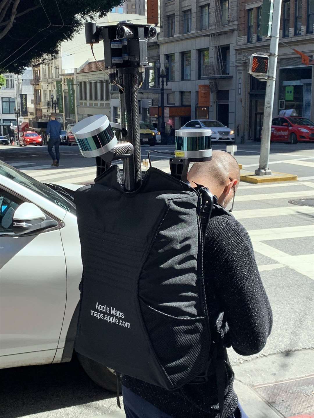 The backpacks house cameras and sensors used to gather mapping data (Apple/PA)