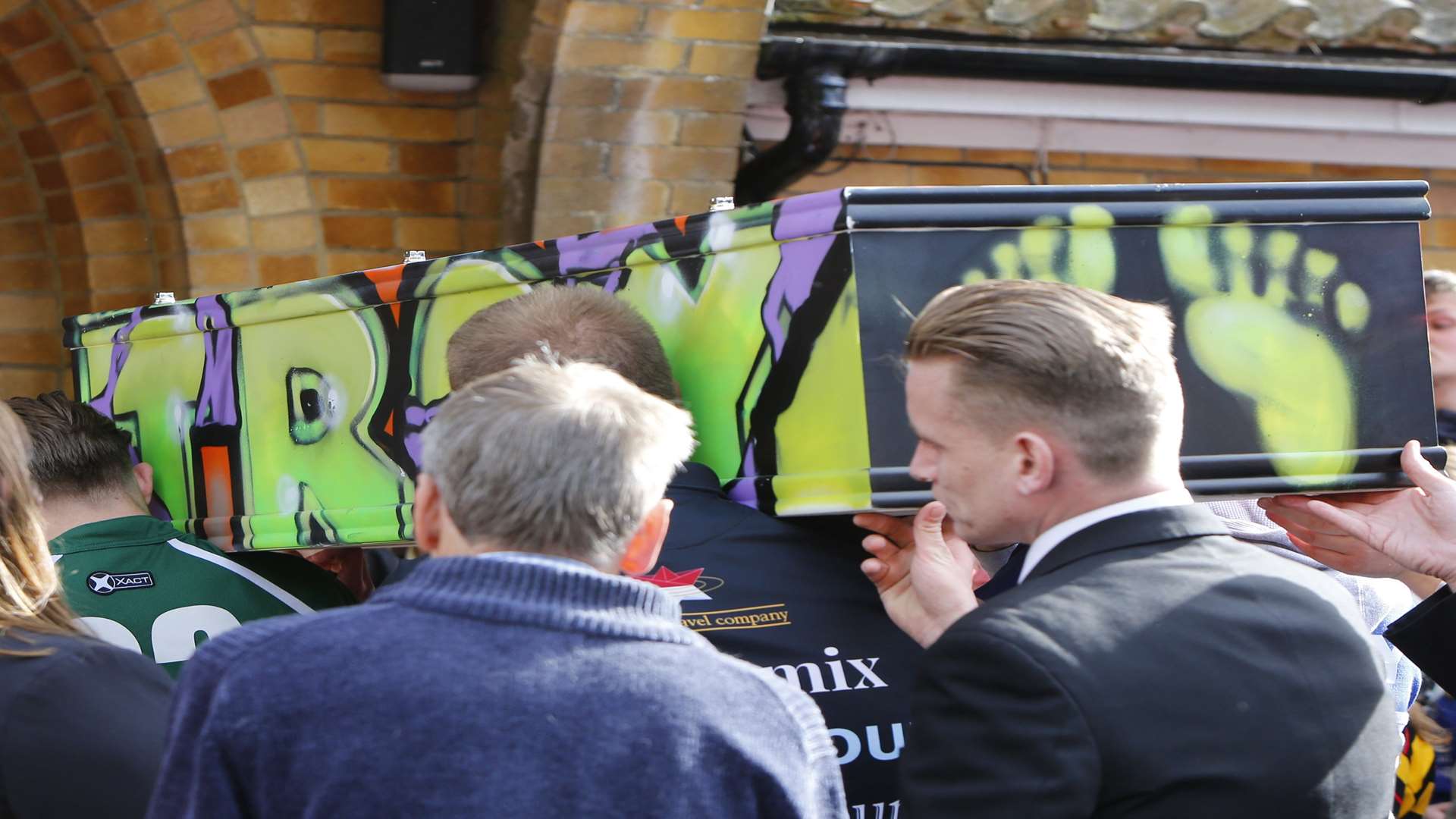 Troy Philpott's coffin is carried into the chapel