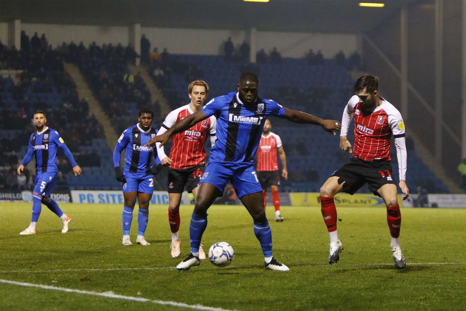 Gillingham forward John Akinde holds off some of Cheltenham's defenders Picture: Andy Jones