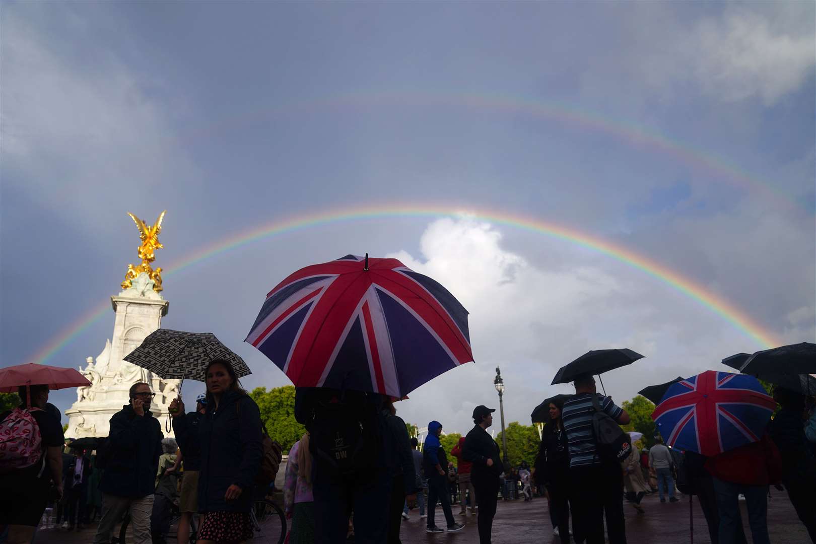 A rainbow was seen as members of the public gathered outside Buckingham Palace in central London, hours before Queen Elizabeth II’s death was announced (Victoria Jones/PA Images)