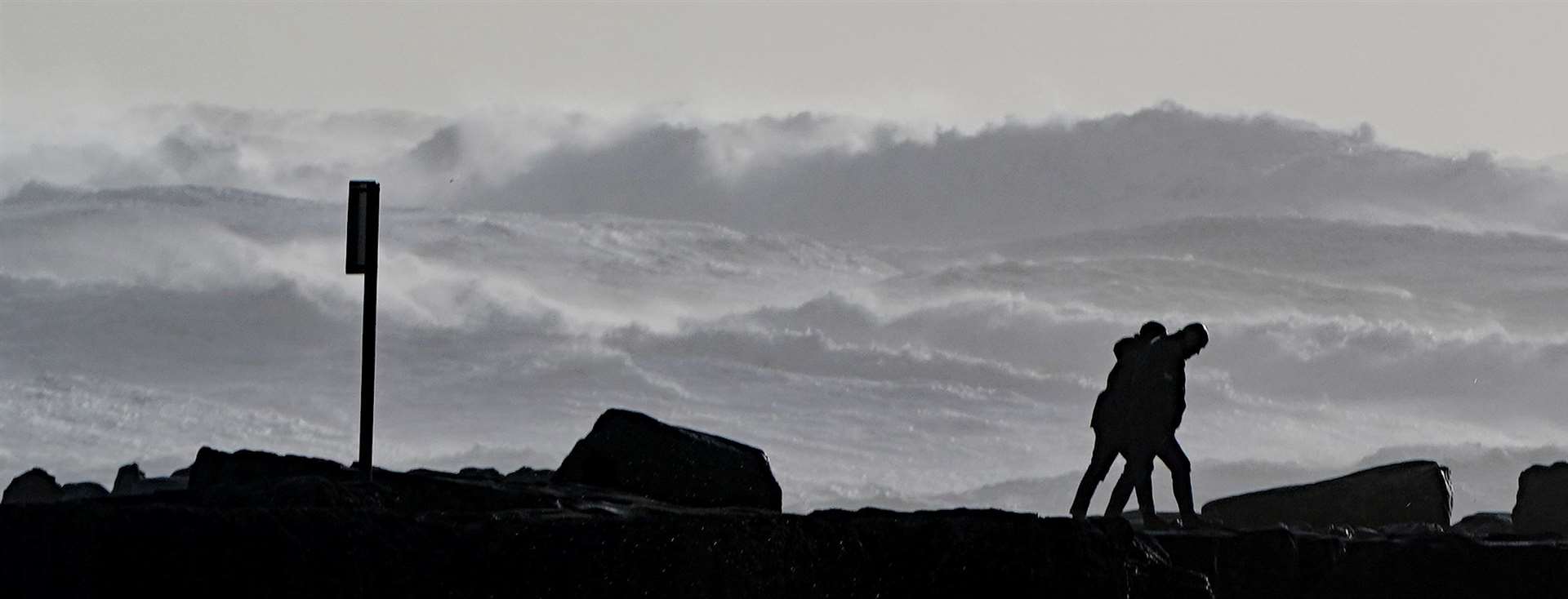 People watch high waves in Doolin in County Clare on the west coast of Ireland (Niall Carson/PA)