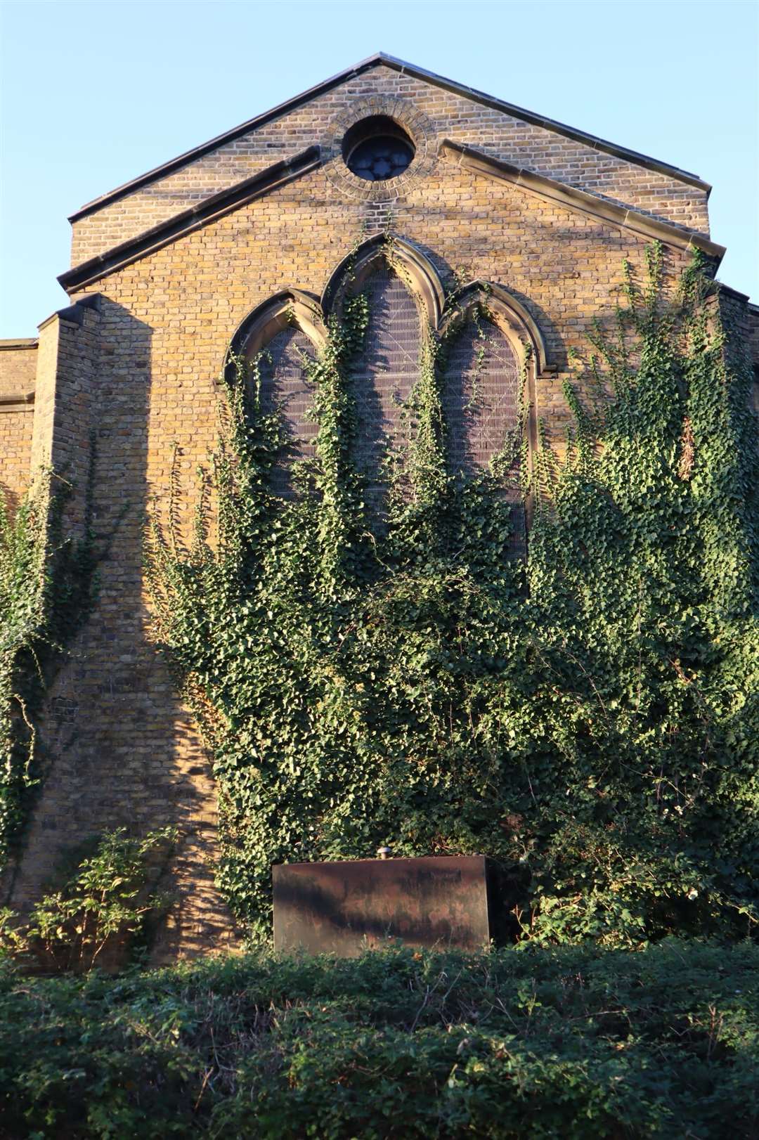 Ivy is blocking out light from the stained glass window at Holy Trinity Church in Trinity Road, Sheerness
