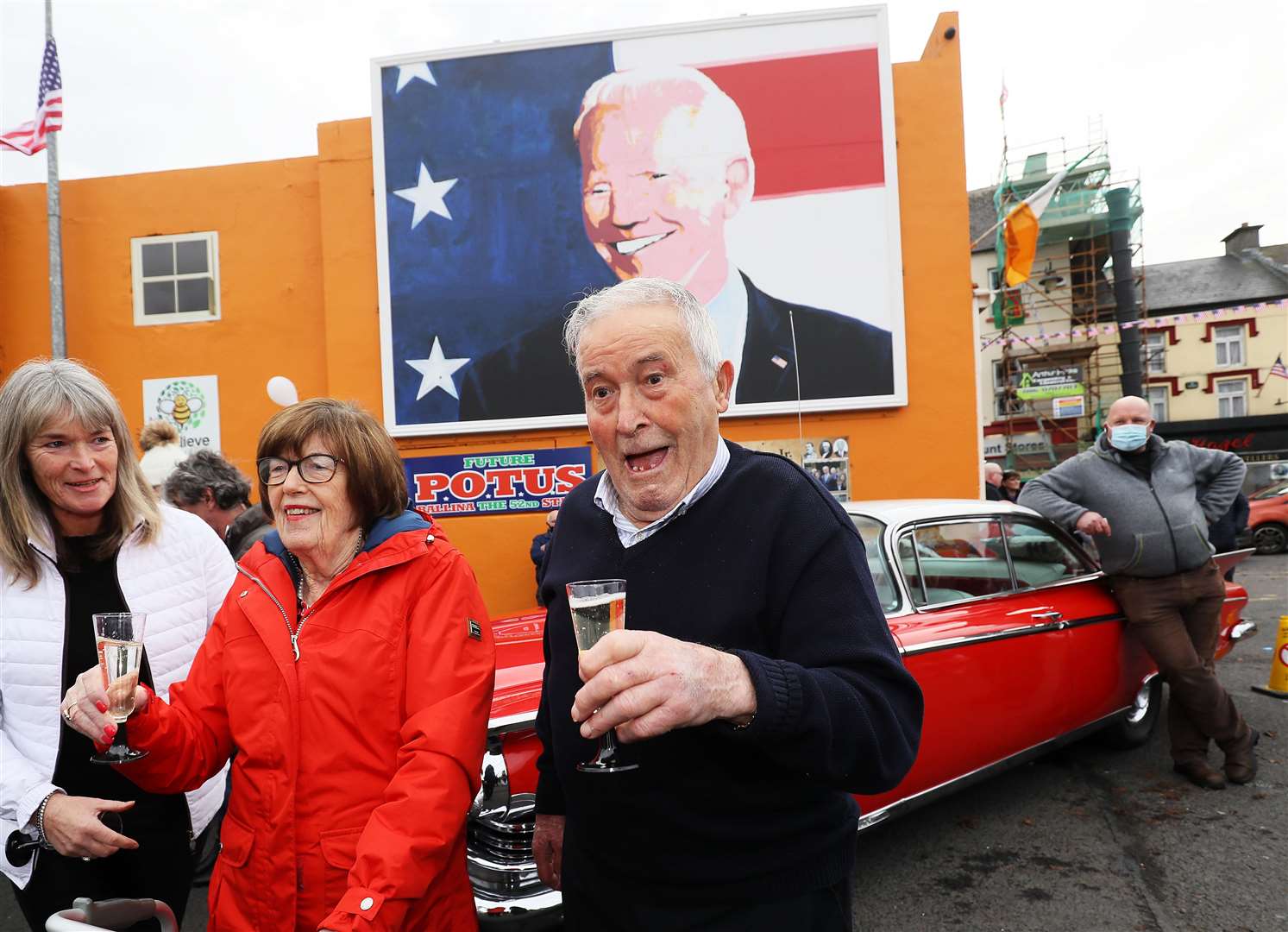 Brendan Blewitt and his sister Breege Bourke (second left) cousins of US president-elect Joe Biden begin celebrating in anticipation of the results of the US election in his ancestral home of Ballina, Co Mayo, Ireland (PA)