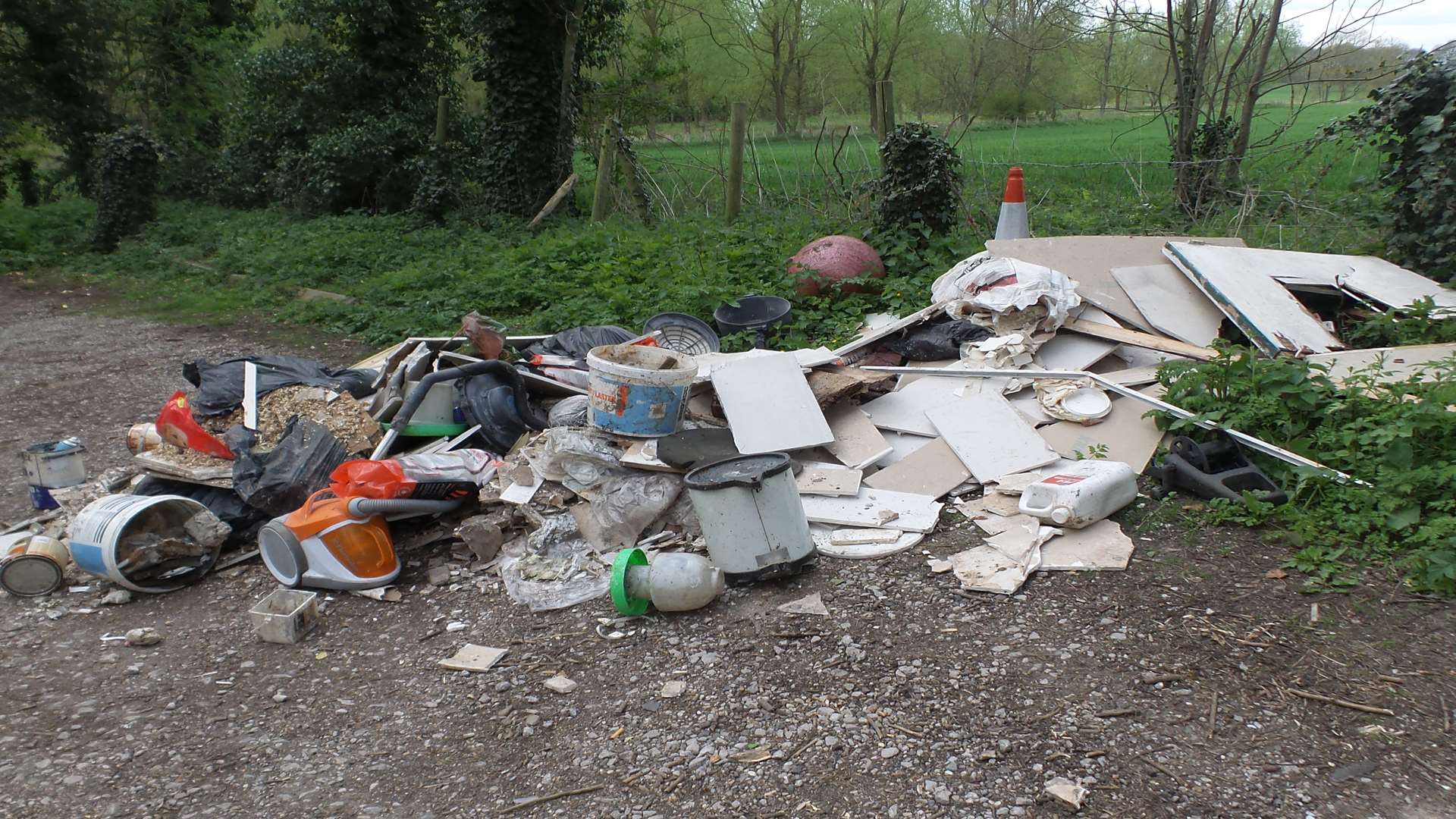 A large load of rubbish has been dumped by the entrance to the church