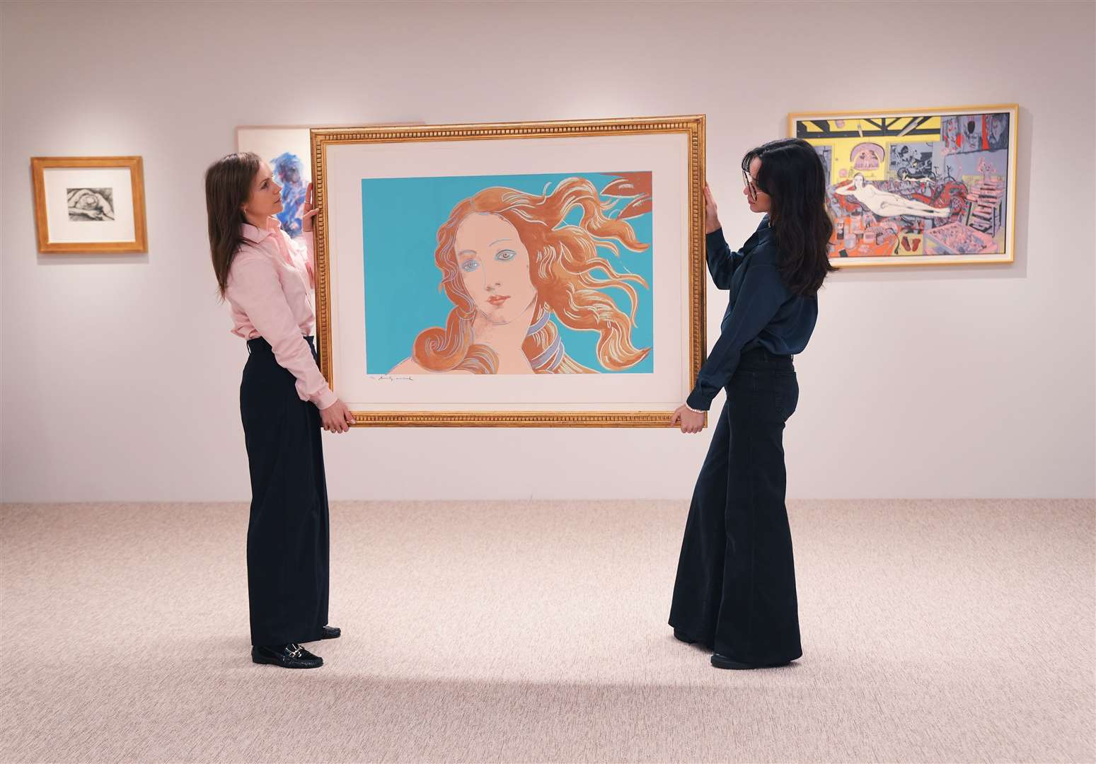 Gallery staff holding a piece by Andy Warhol (Yui Mok/PA)