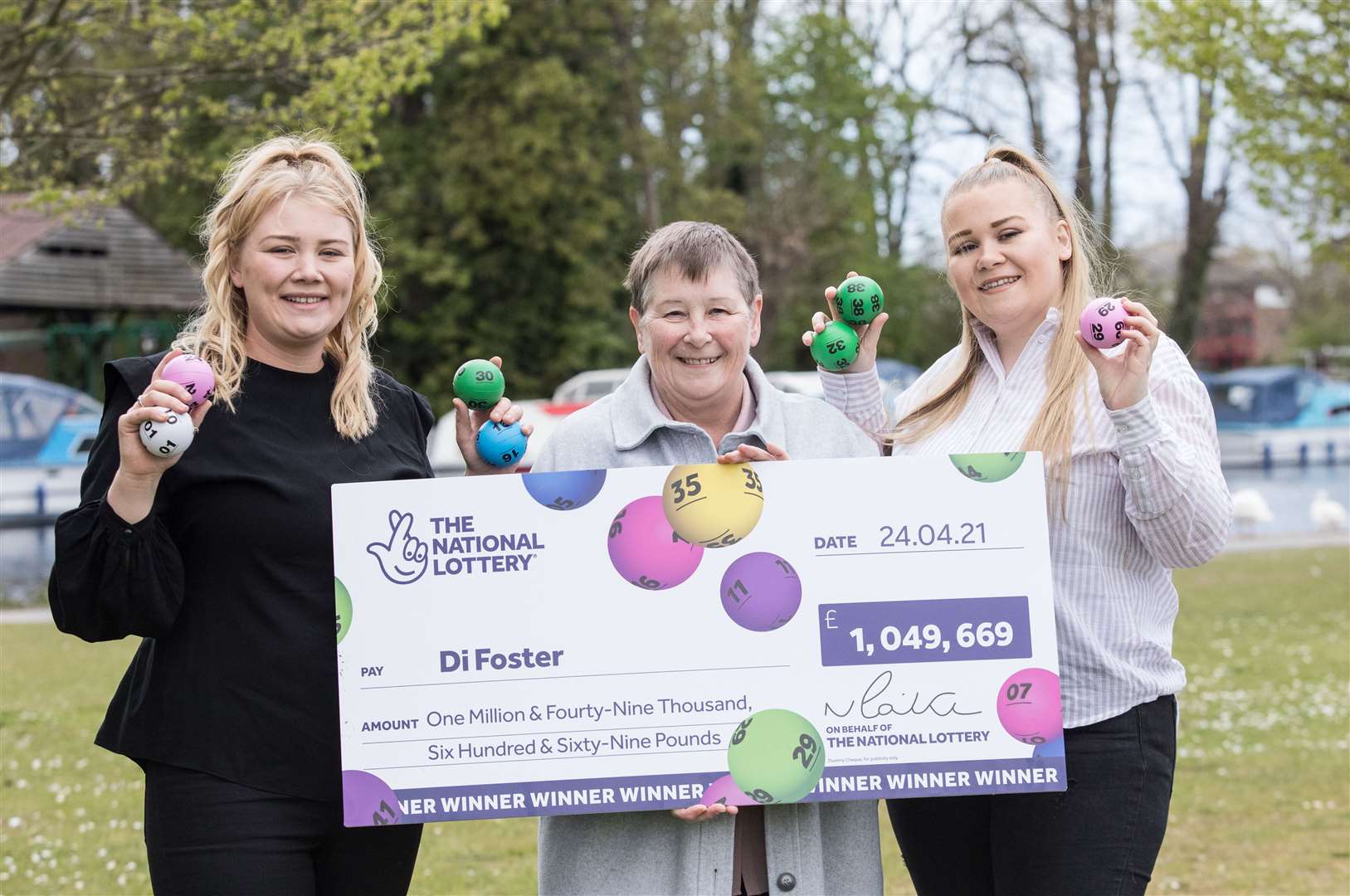 Di Foster celebrating her £1 million win with her daughters Kelly (left) and Jodie (right) (Camelot/PA)