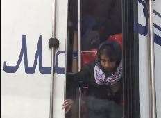 Migrants appear to be seen being escorted from the lorry