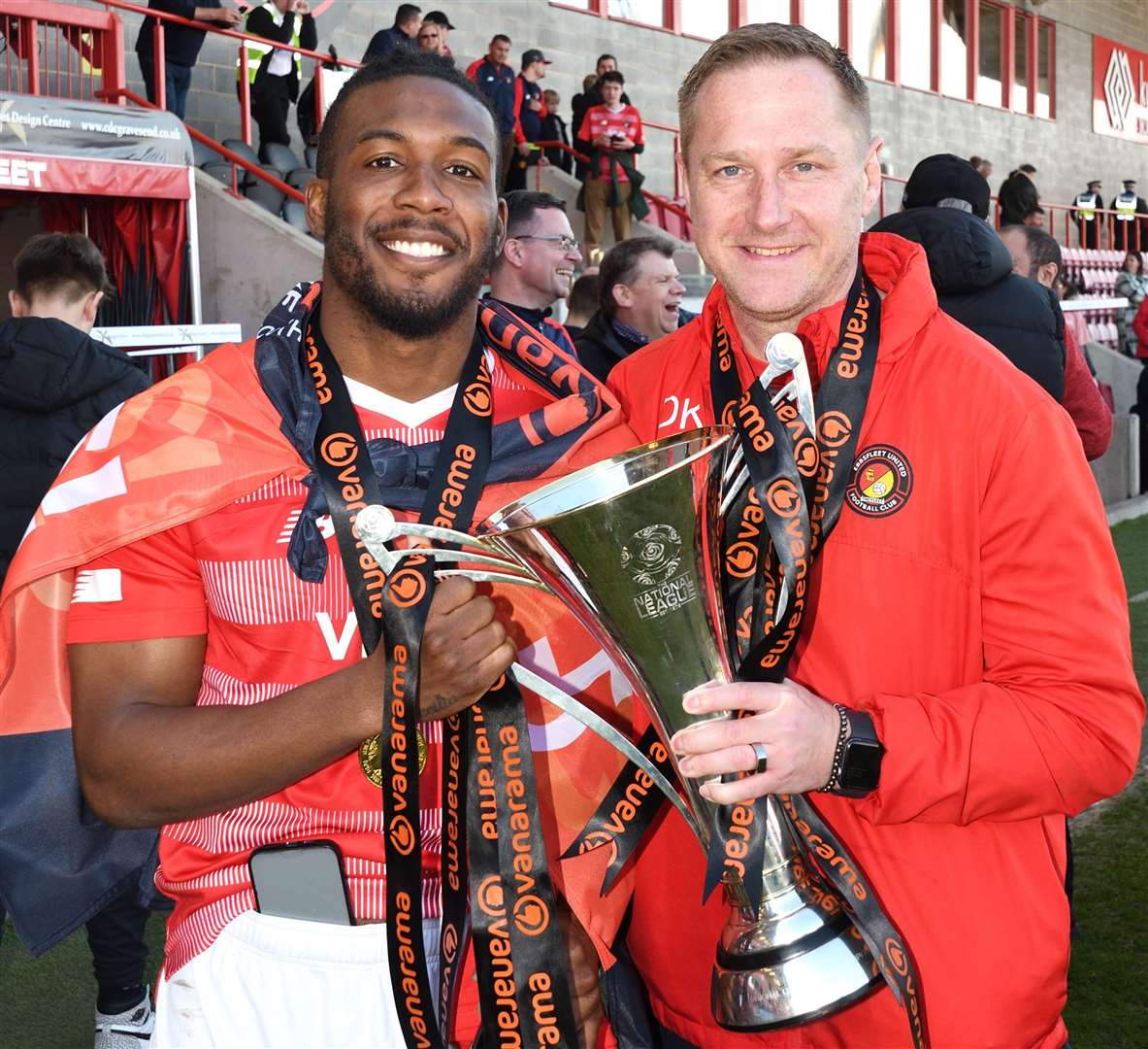 Ebbsfleet boss Dennis Kutrieb and hat-trick hero Dominic Poleon with the National League South trophy. Picture: Simon Hildrew