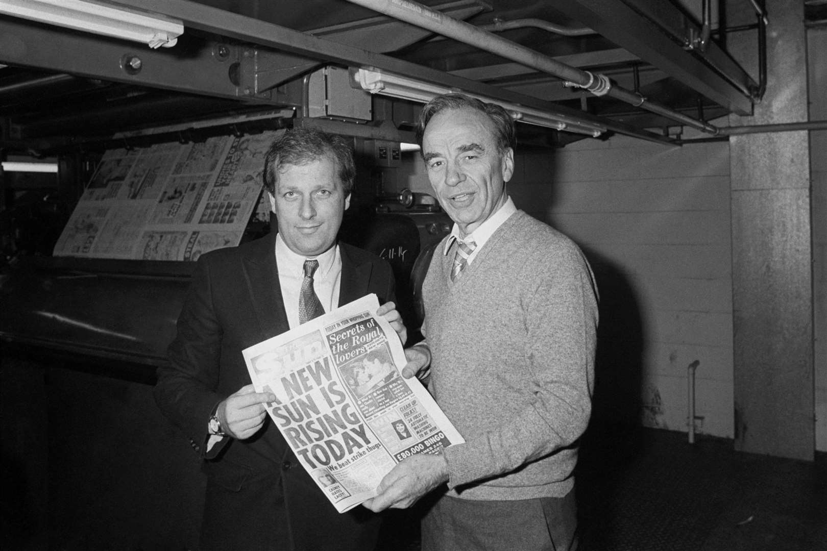 Kelvin MacKenzie (left) and Rupert Murdoch holding copies of The Sun at the paper’s print works in Wapping, east London, in January 1986 (PA)