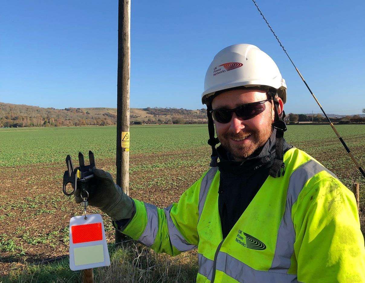 Rob Preece, a linesman at UK Power Networks, with one of the bird diverters in West Hythe (5445204)