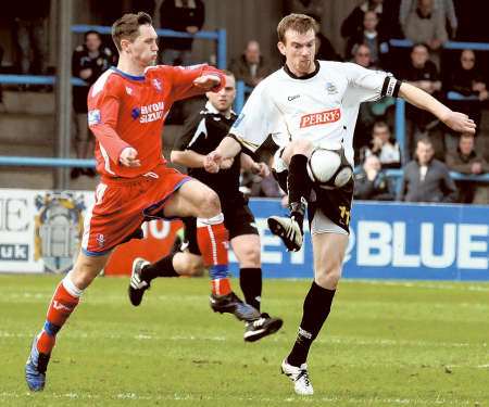 Dean Rance, left, closes down Dover’s ex-Gills midfielder Barry Cogan on Saturday