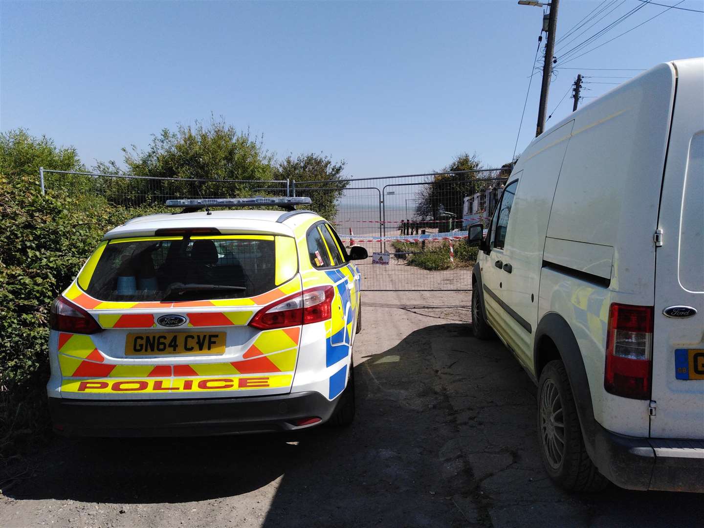 Police remain at the scene of the landslide