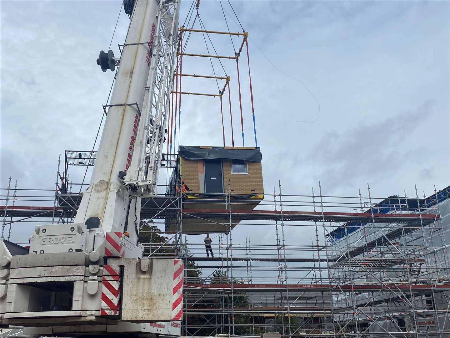 The container-sized section had to be lifted over scaffolding and lowered