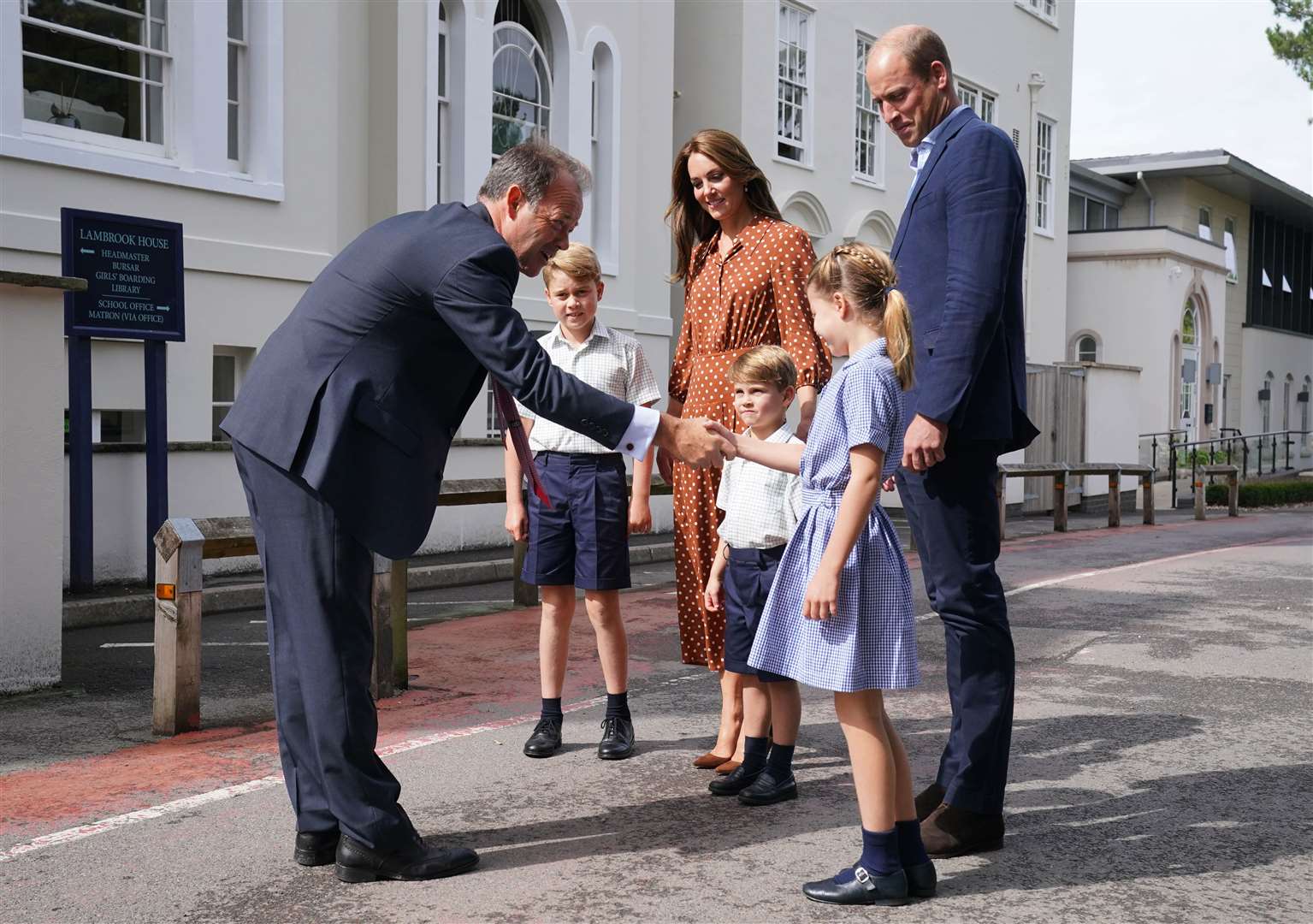 Headmaster Jonathan Perry greets the children as they arrive for a settling-in afternoon (Jonathan Brady/PA)