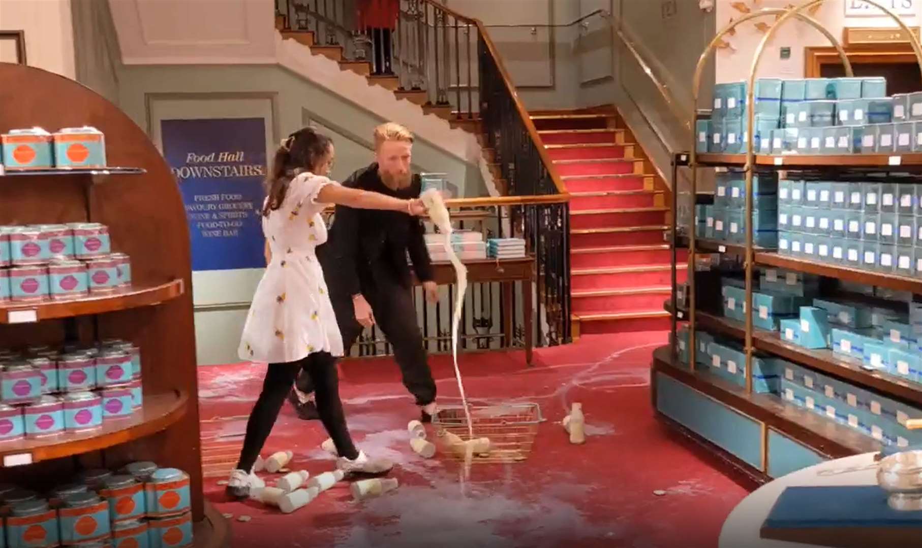 The Animal Rebellion protesters poured out milk on the carpet at Fortnum & Mason in London (Animal Rebellion/PA)